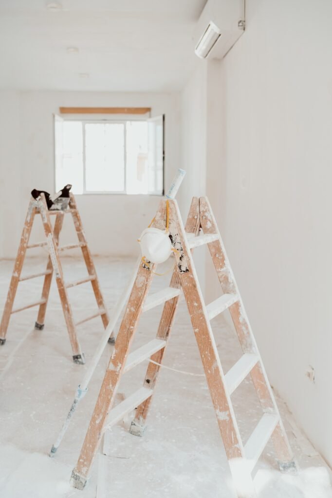 ladders on white room at construction site. Painting walls. Home improvement, renovation